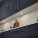Aluminium round recessed LED under cabinet light installed in a kitchen