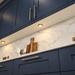 Brass Round Surface Mounted LED Under Cabinet Light installed beneath kitchen cabinets